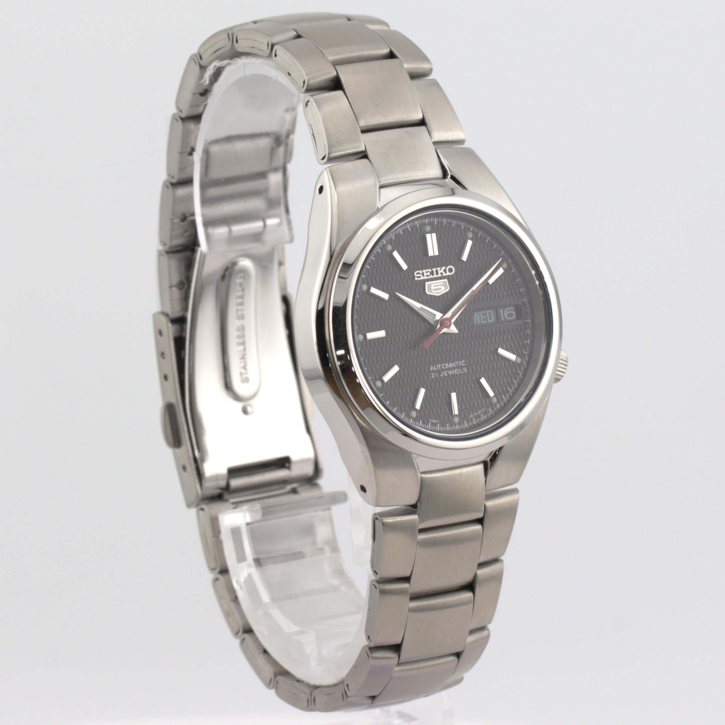 Seiko SNK607K1 Black Dial Seiko 5 Automatic Watch side view showcasing silver stainless steel bracelet and textured black dial.