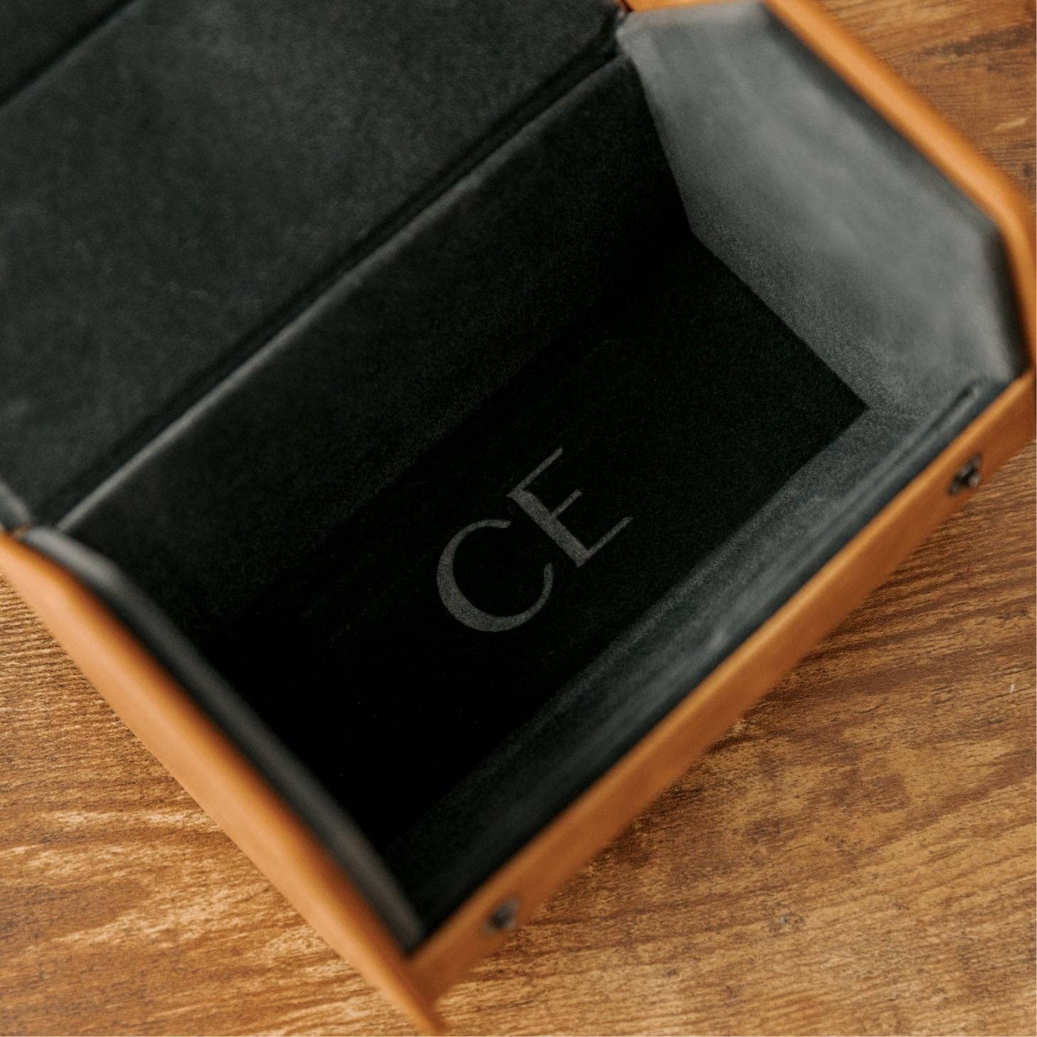 Inside view of the 2-slot travel watch roll featuring a dark gray velvet interior and the letters CE.