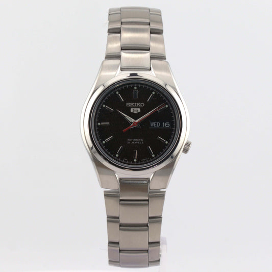Seiko 5 automatic watch SNK607K1 featuring a black dial with luminous hands and a polished stainless steel case.