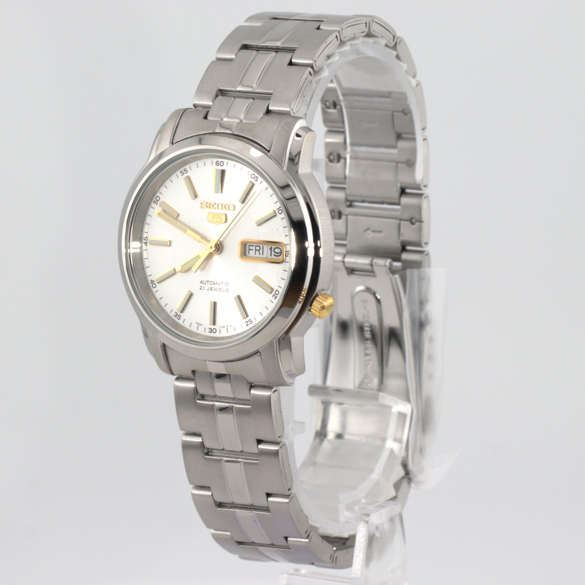 Seiko 5 automatic watch white dial on display, showcasing its elegant design and stainless steel bracelet.