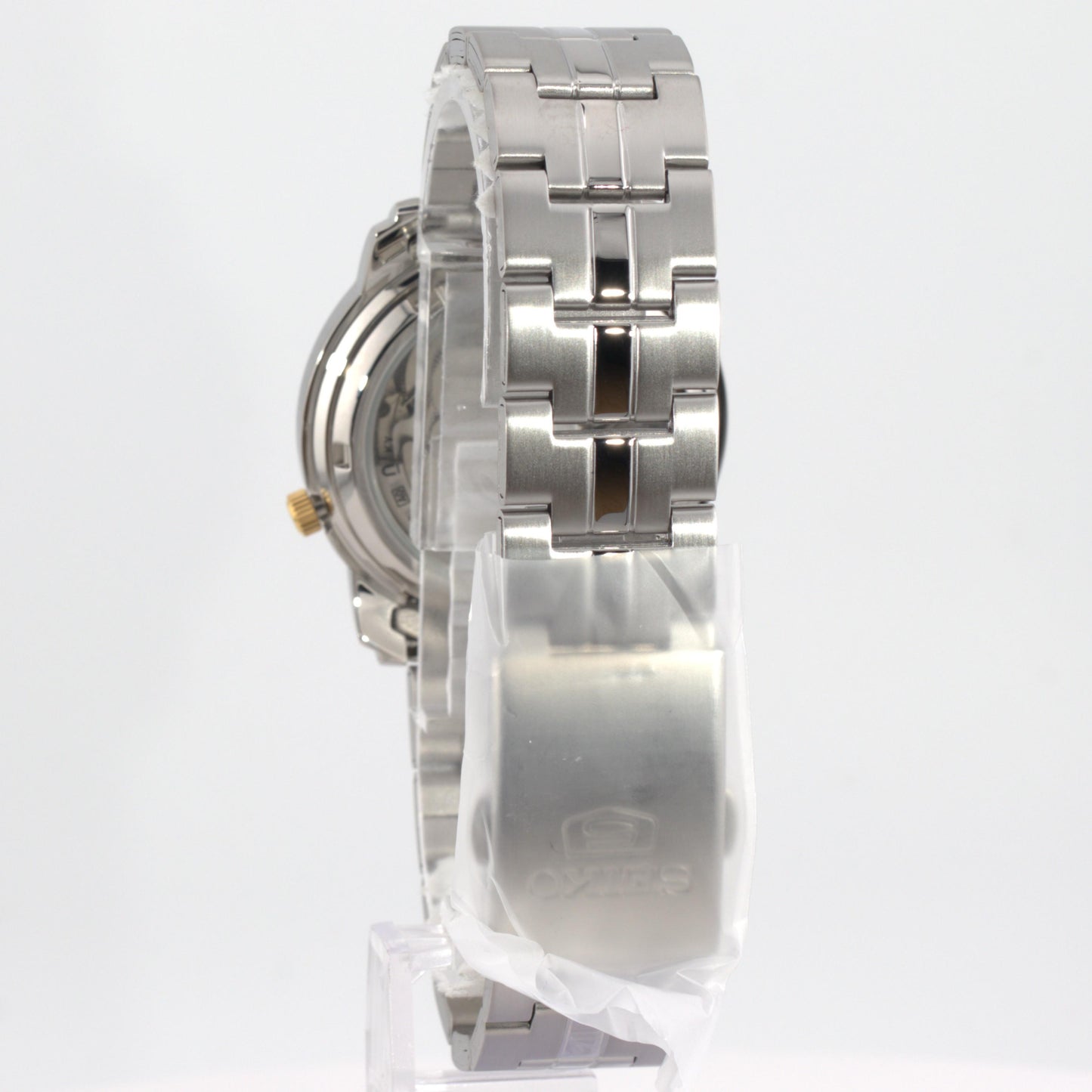 Seiko 5 automatic watch white dial side view showcasing the stainless steel bracelet and case design.