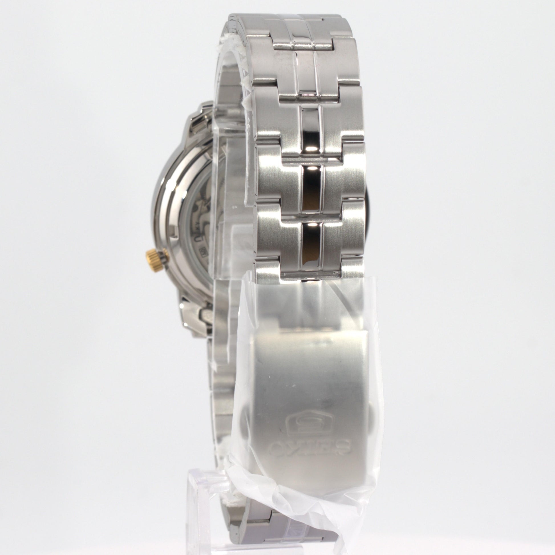 Seiko 5 automatic watch white dial side view showcasing the stainless steel bracelet and case design.