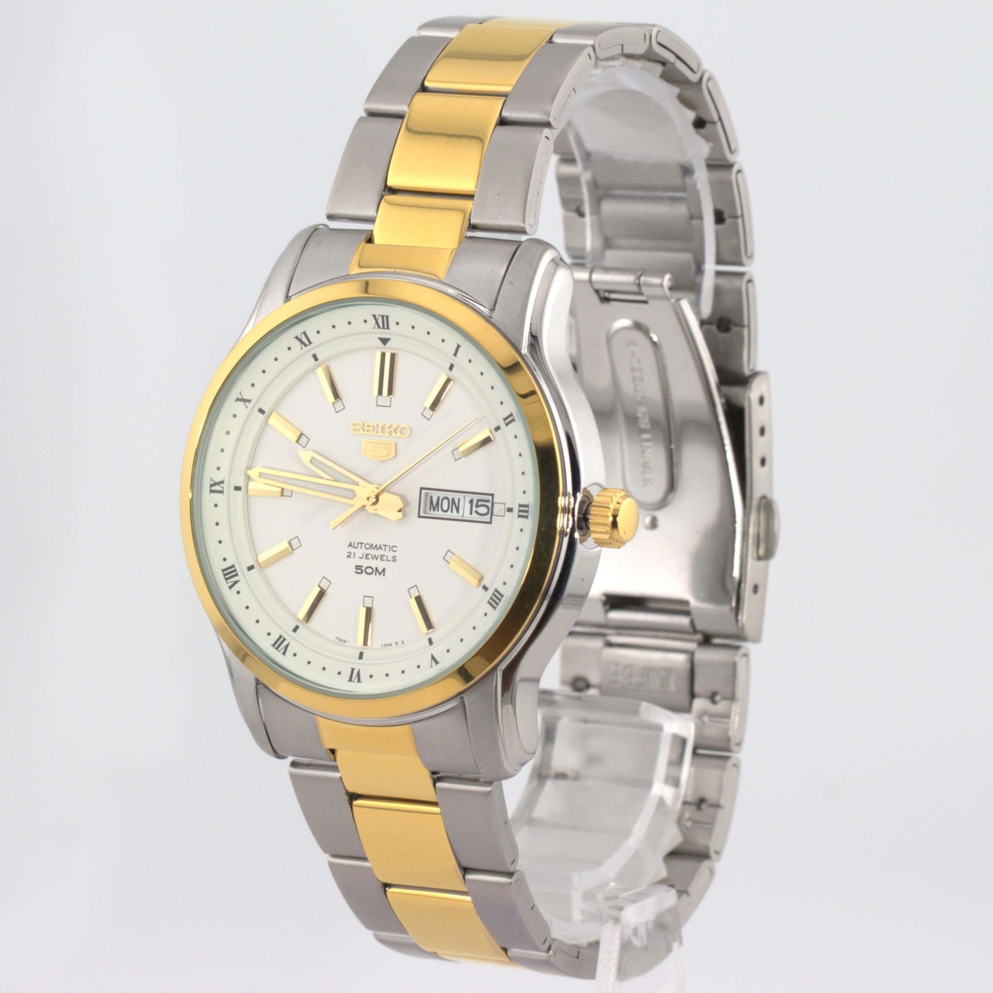 Seiko 5 automatic watch white dial with stainless steel and gold bracelet in a stylish display.