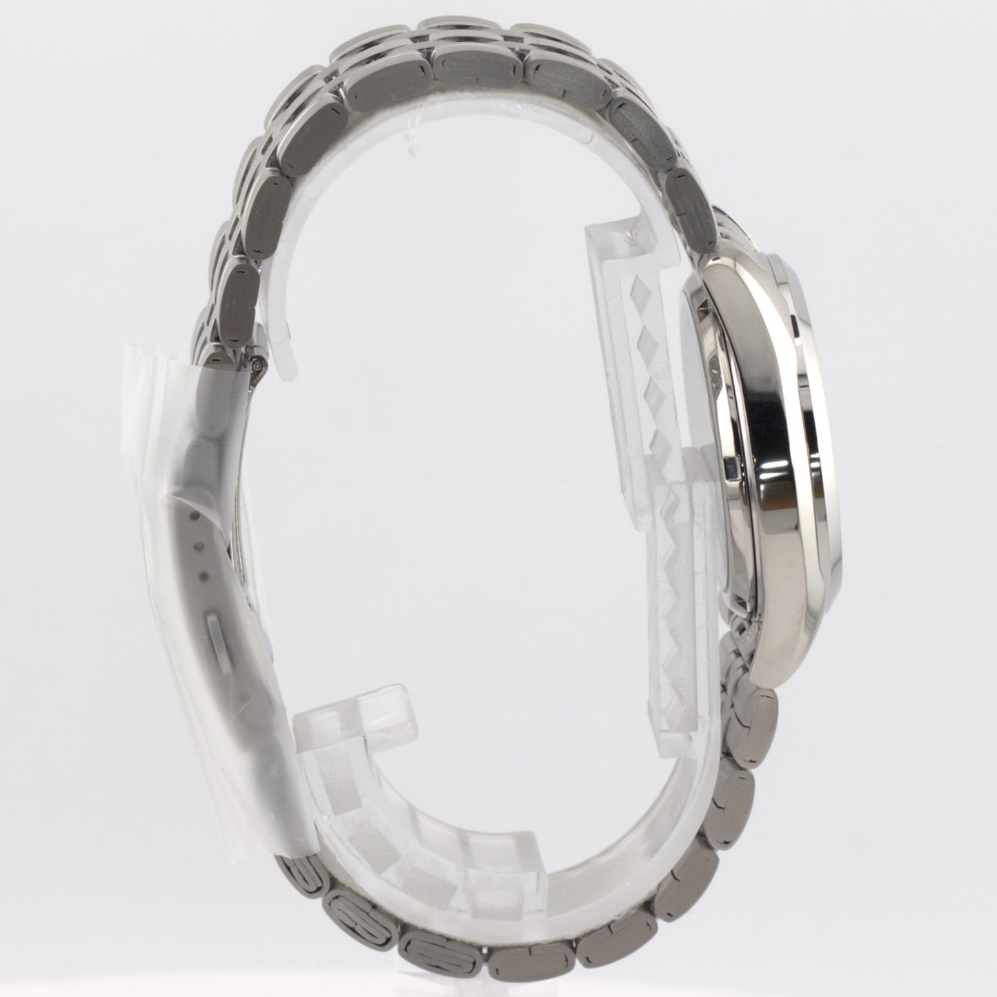 Seiko 5 automatic white dial watch side view showing stainless steel bracelet and case design.