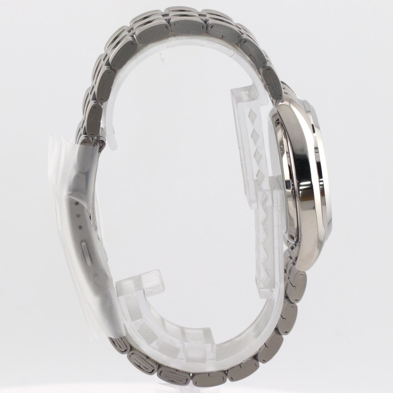 Seiko 5 automatic white dial watch side view showing stainless steel bracelet and case design.