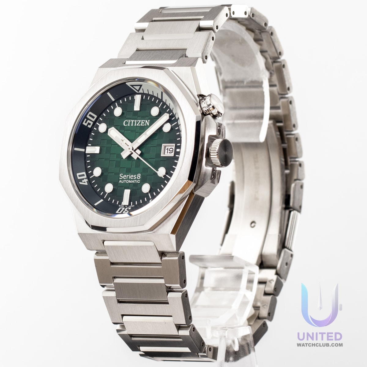 Citizen Series8 green dial watch showcasing textured green dial and stainless steel case on a display stand.