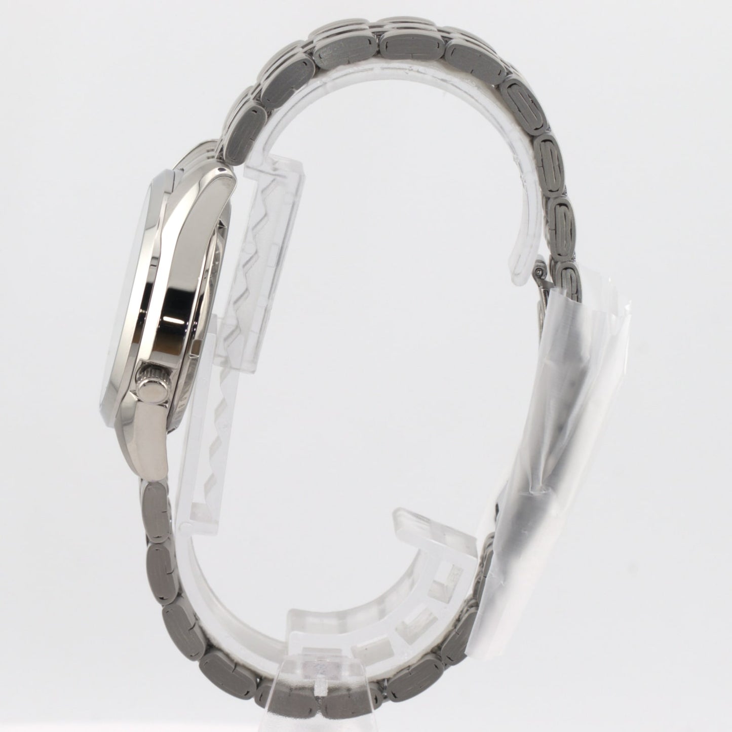 Seiko 5 automatic white dial watch side view showing stainless steel case and bracelet.