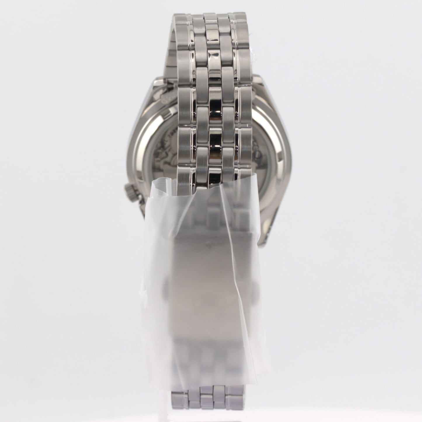 Seiko 5 automatic white dial watch showing its stainless steel bracelet and rear view design
