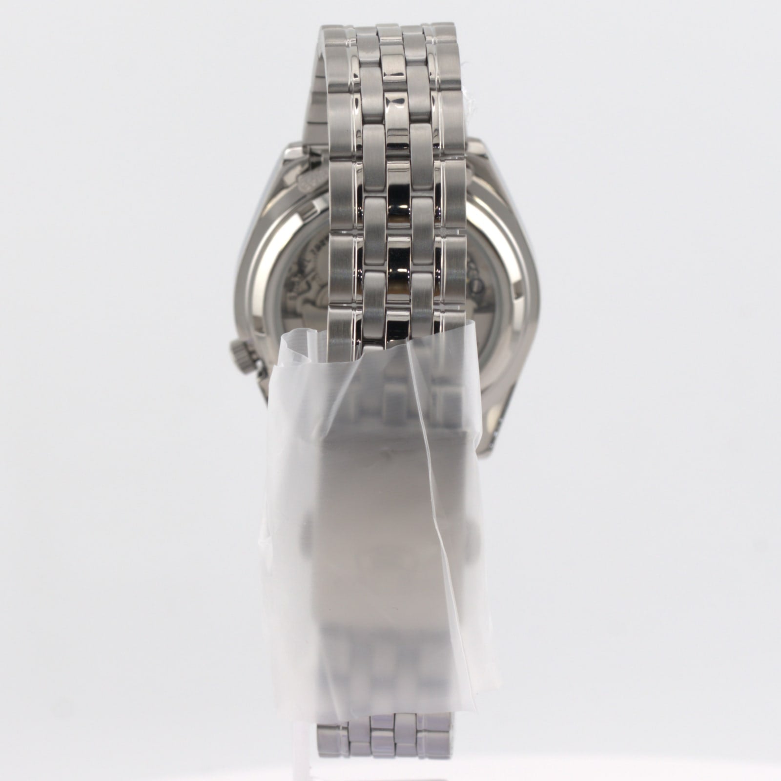 Seiko 5 automatic white dial watch showing its stainless steel bracelet and rear view design