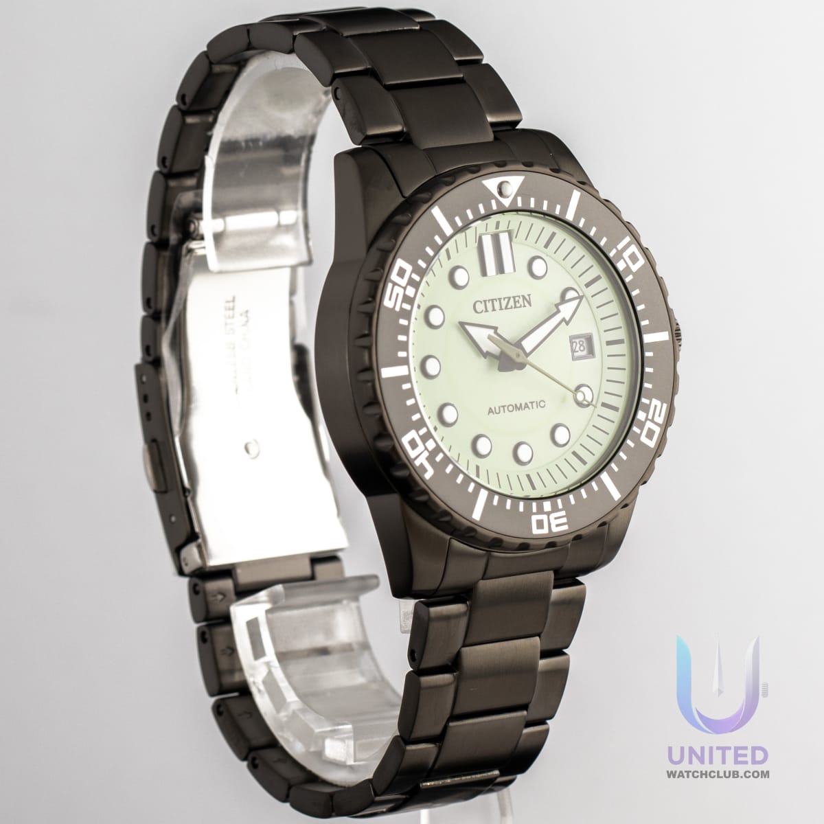 Citizen mechanical watch green dial showcased on a black stainless steel bracelet, featuring a luminous face.