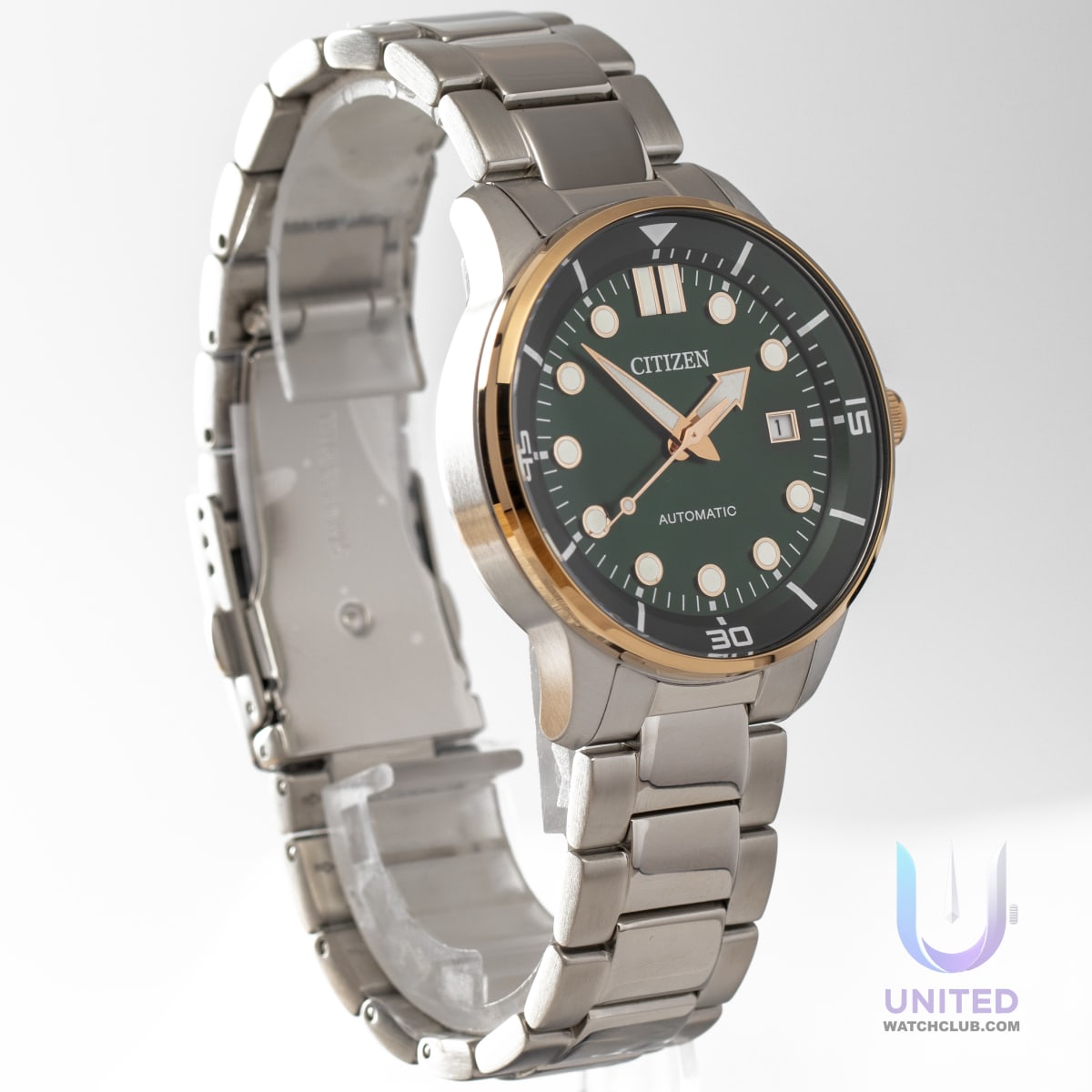 Citizen automatic green dial watch with stainless steel case and gold-tone bezel.
